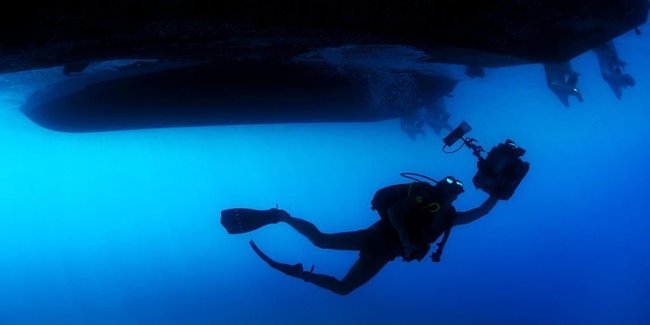 diver under a boat