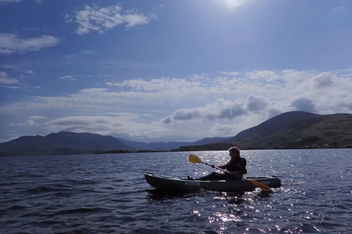 a man rowing a boat in a body of water