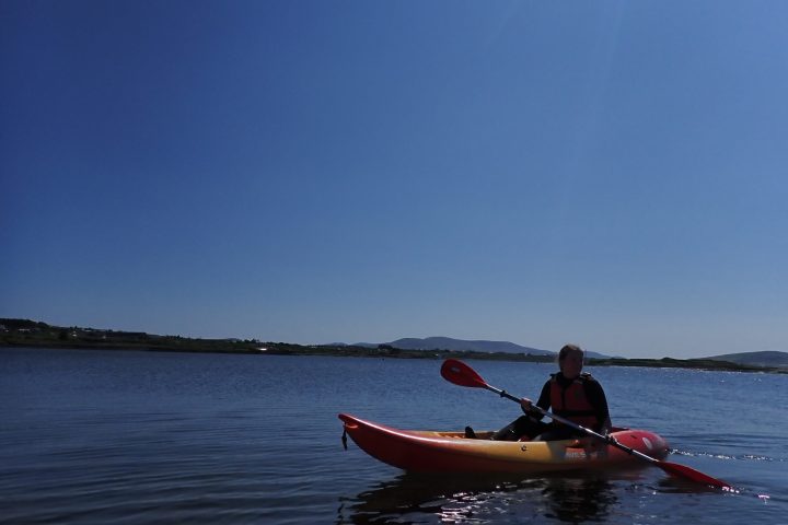 a man riding on the back of a boat in a body of water
