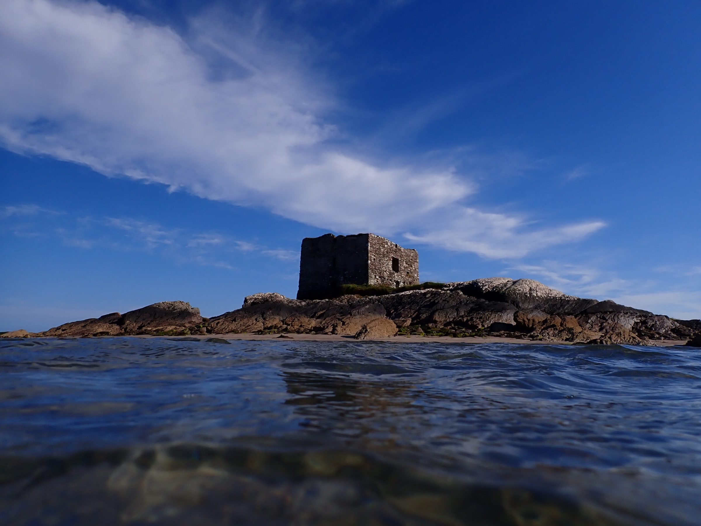 a body of water with a mountain in the background