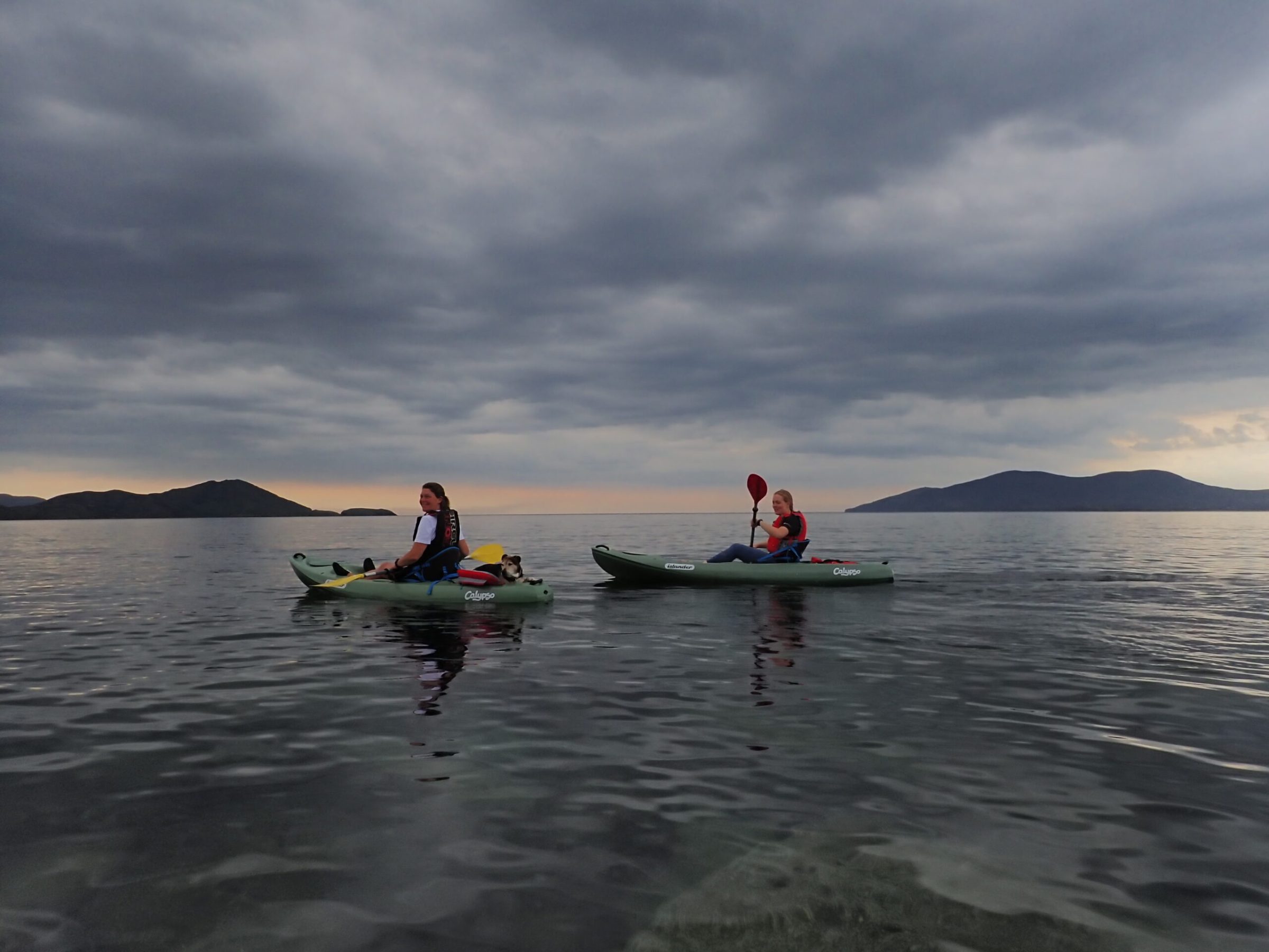 a group of people riding on the back of a boat in the water