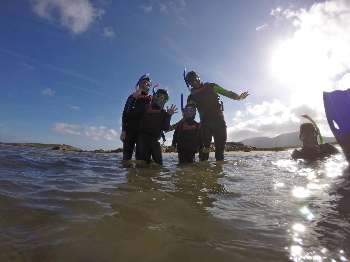 a couple of people that are standing in the water