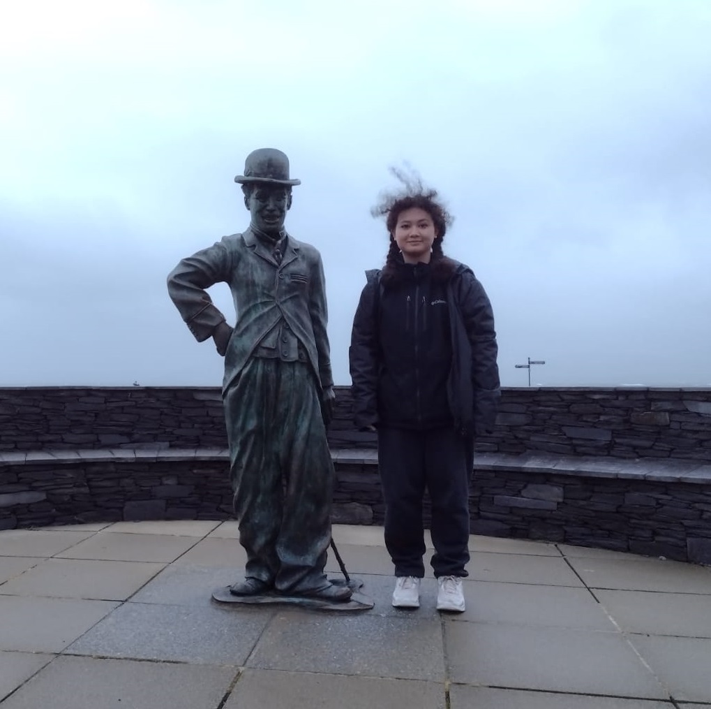 a man standing in front of a statue