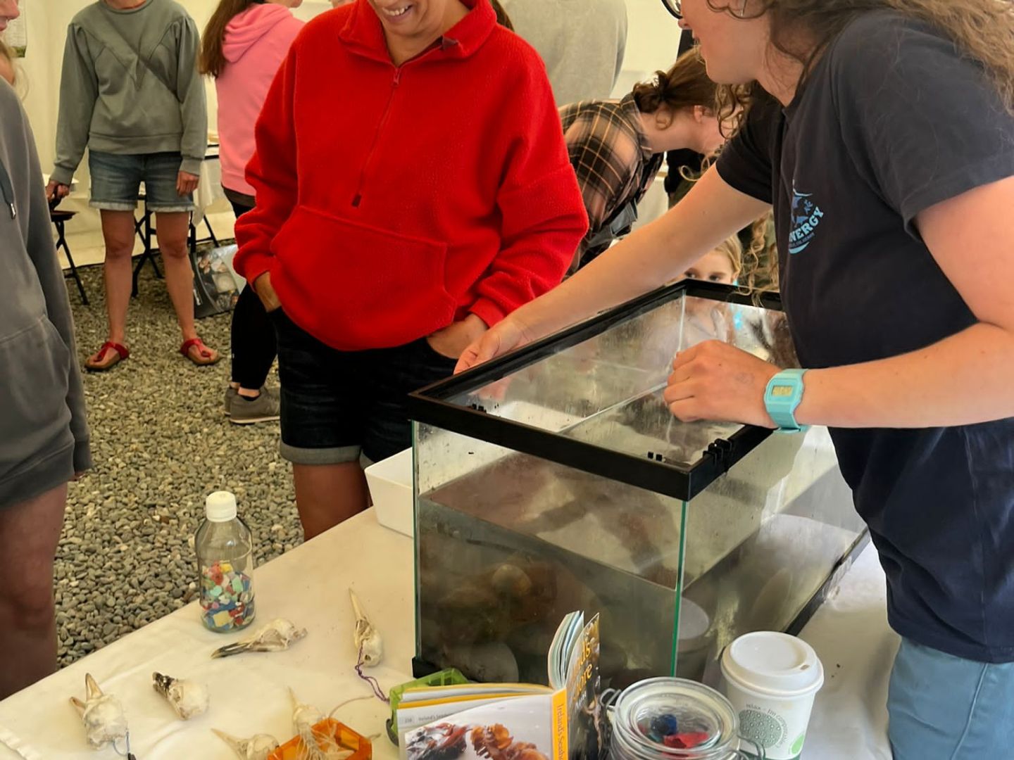 a group of people standing around a table
