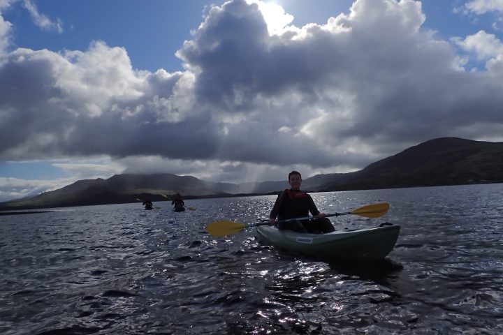 a man riding on the back of a boat in a body of water