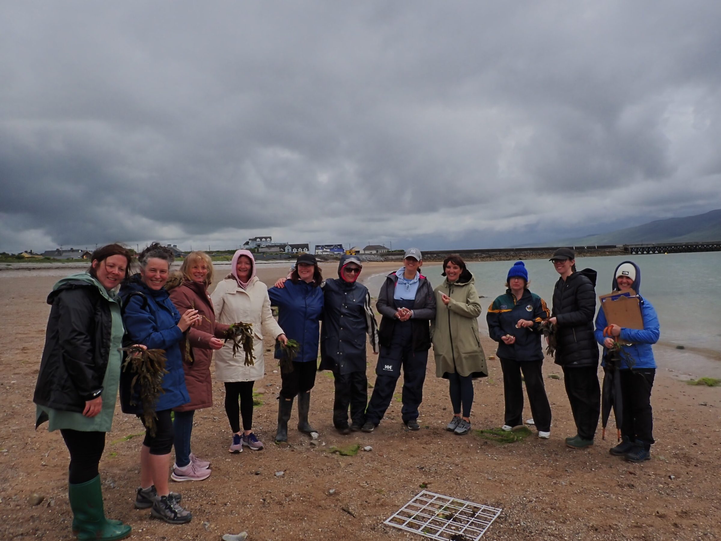 a group of people standing in front of a cloudy sky