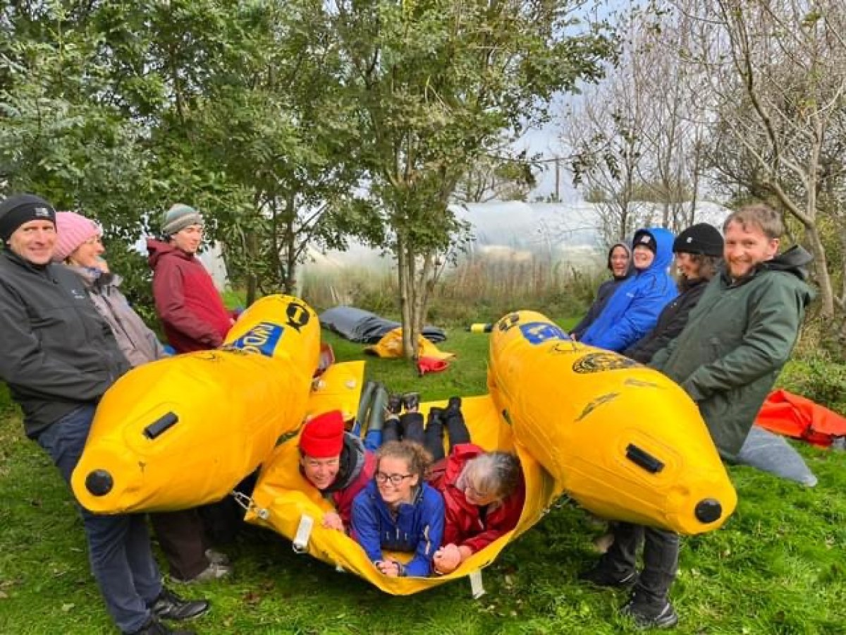 a group of people sitting on a statue of a person