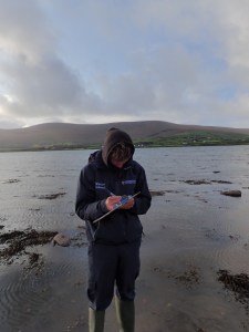 a man standing next to a body of water